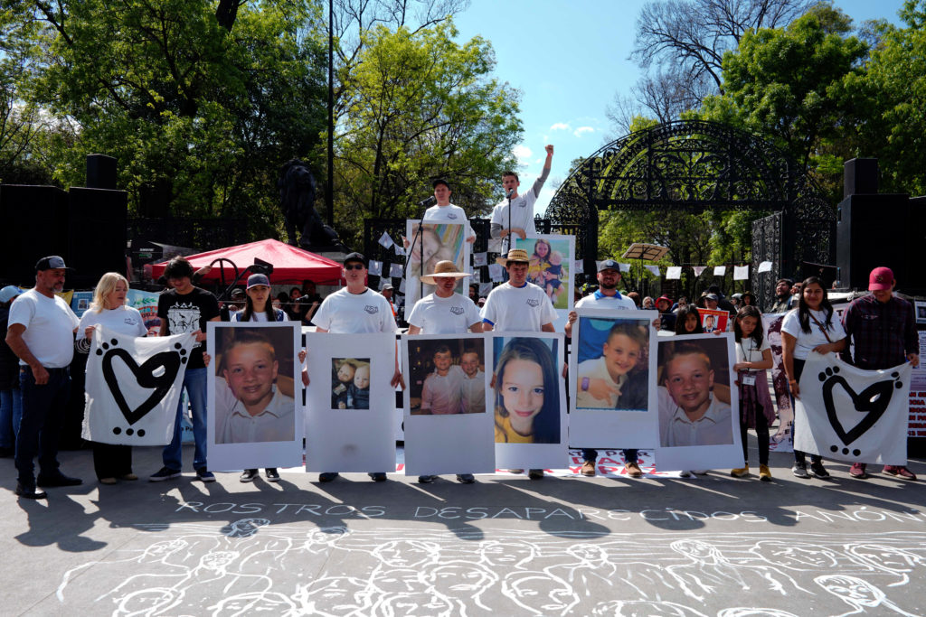 Members of the Lebaron family hold pictures of relatives who were killed by unknown assailants, during a demonstration against violence in Mexico City
